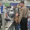 Daviess County Sheriff Larry Adams Jr. in the check out line during the Shop with a Cop event.